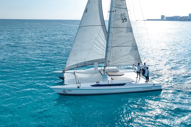 All-Inclusive Isla Mujeres Catamaran with Free Transportation - Boarding the catamaran with a mimosa