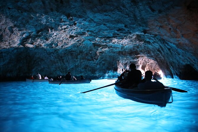 Blue Grotto and Capri Boat Tour with Aperitivo Swim and Snorkel - Capri from the sea, with caves at every turn