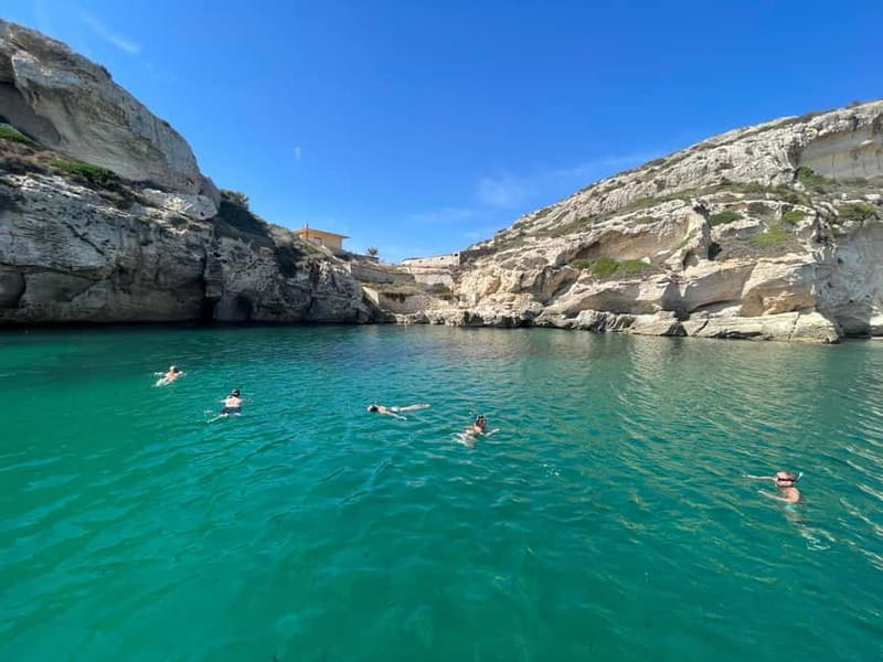 Cagliari: Boat Tour with 4 Swim Stops, Snorkeling & Prosecco - Cala Fighera and the sea caves near Sella del Diavolo