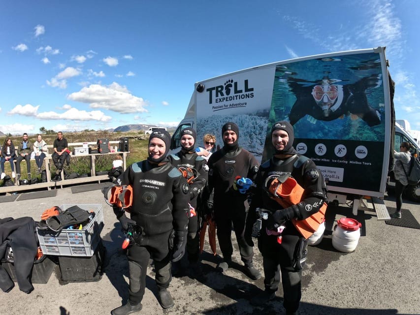 From Reykjavik: Silfra Snorkeling with Free Photos - Entering the 2°C water