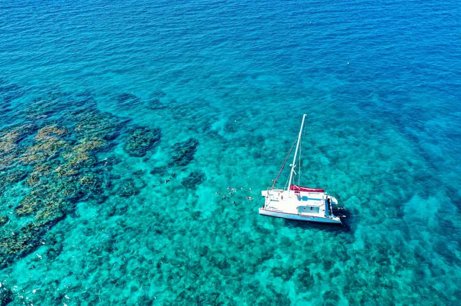 Key West: Reef Snorkel Morning Tour with Breakfast & Mimosas - The catamaran ride home, with beer and coastal views