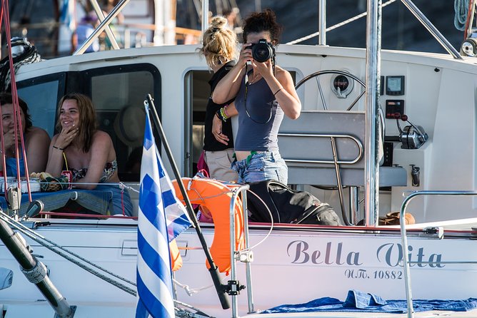 Santorini: Adventurous Catamaran Experience with Snorkeling - Passing beneath Akrotiri Lighthouse